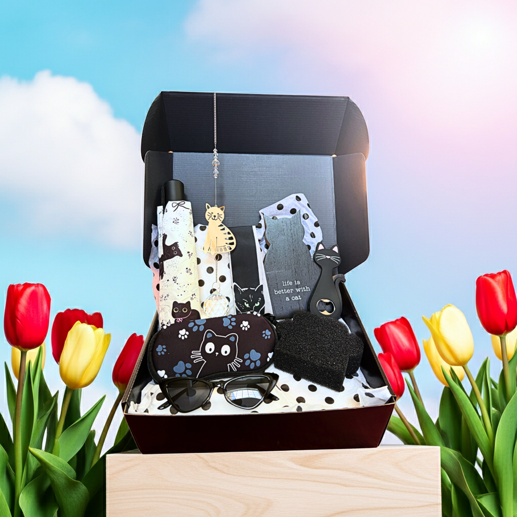 Set of cat-themed items in a box with tulips in the background
