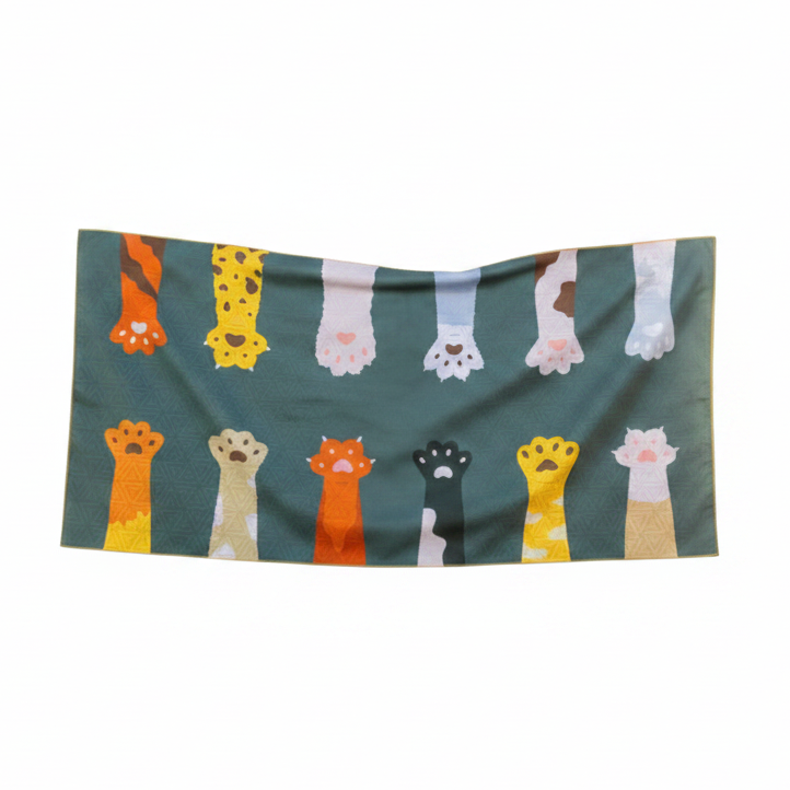 Towel with cartoon cat paw prints on a green background