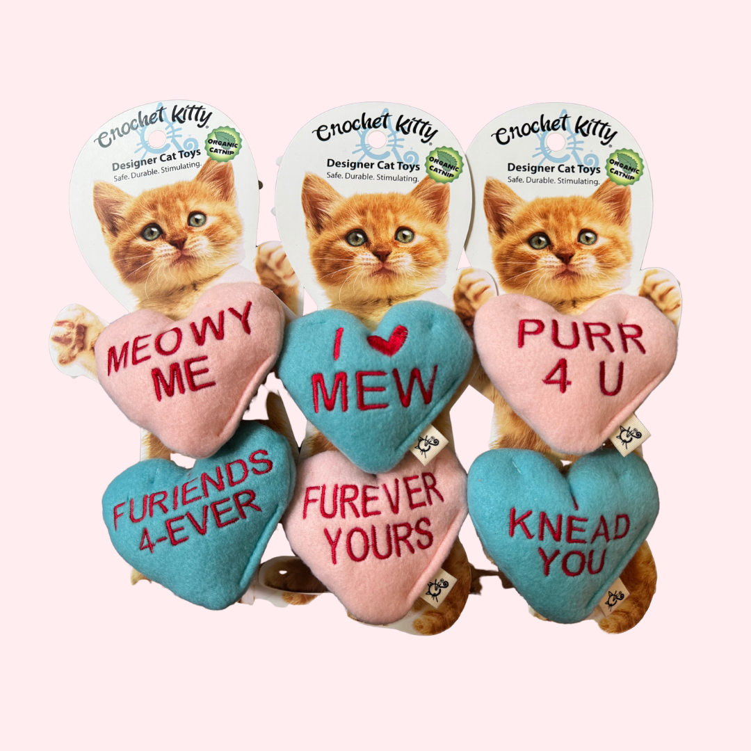 Set of heart-shaped cat toys with romantic phrases on a white background