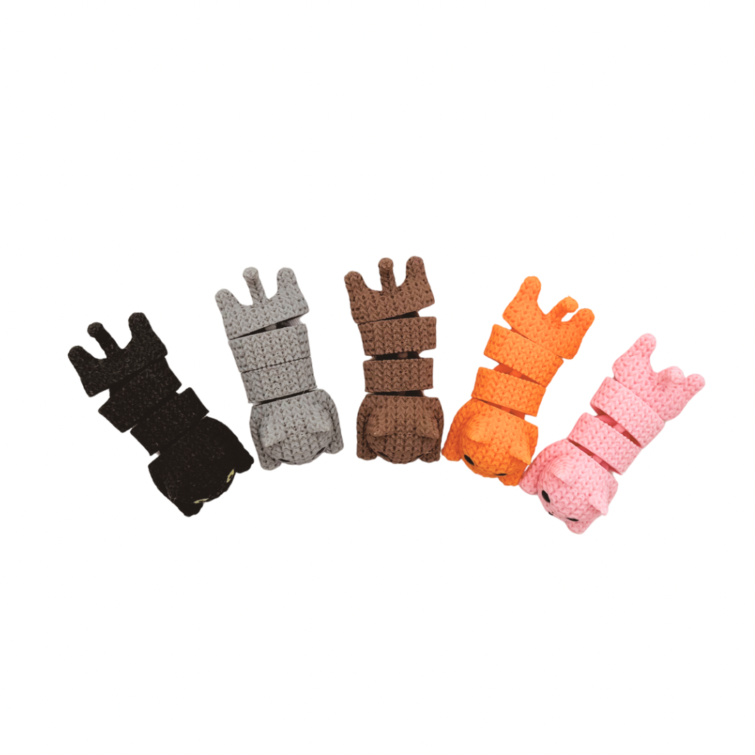 Five colorful plastic Cat Fidget Toys in black, gray, brown, orange, and pink on a white background.