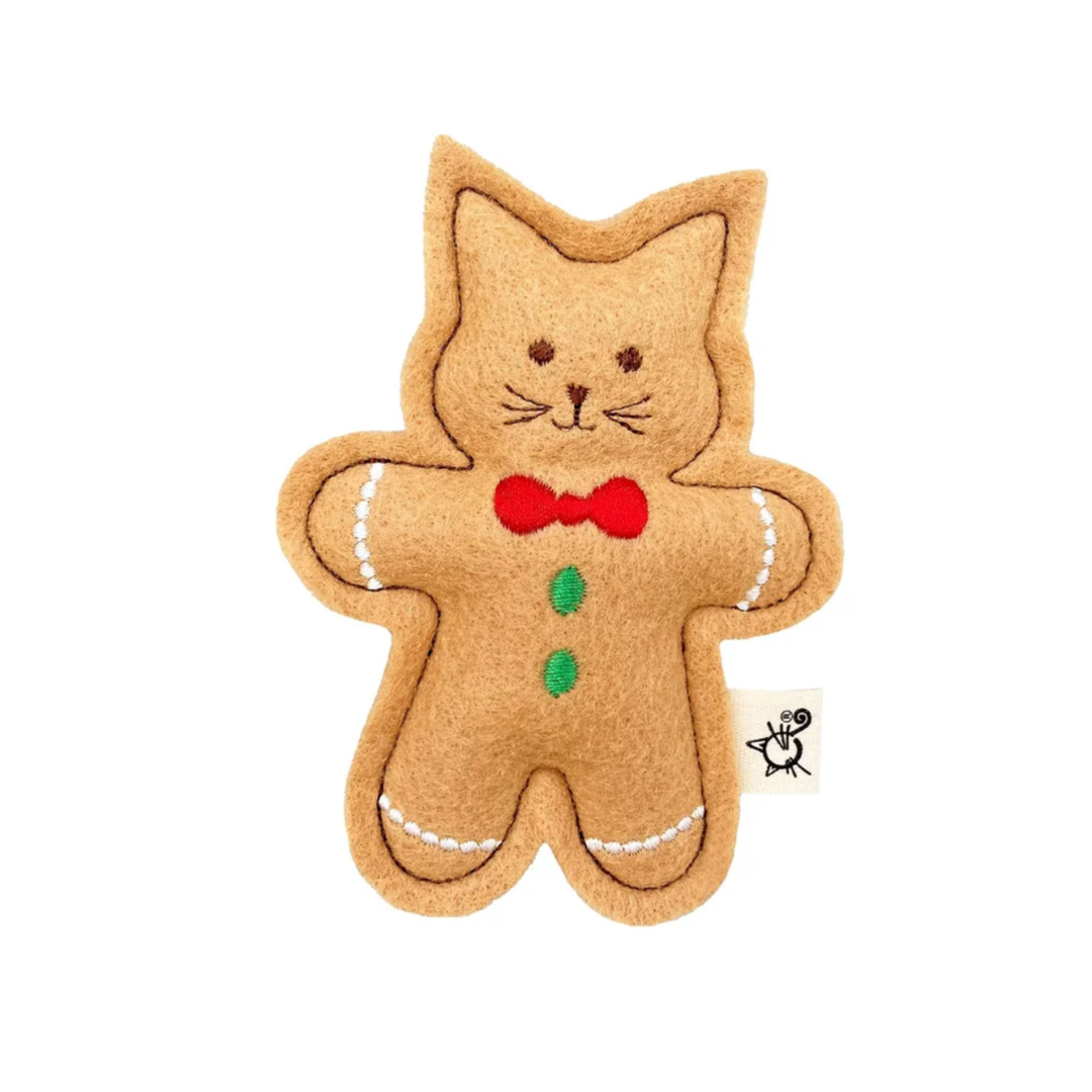 Gingerbread cat-shaped toy with a red bow tie on a white background