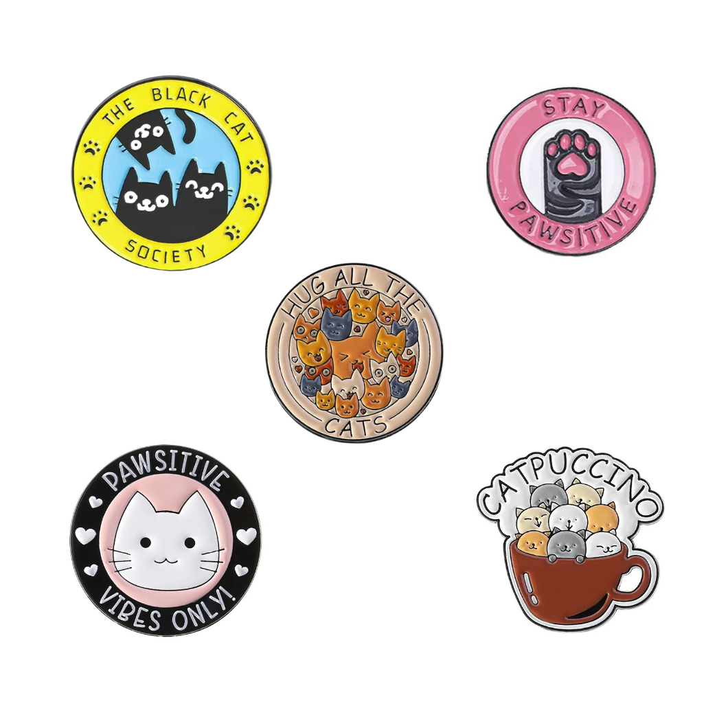 Set of five cat-themed pins on a white background