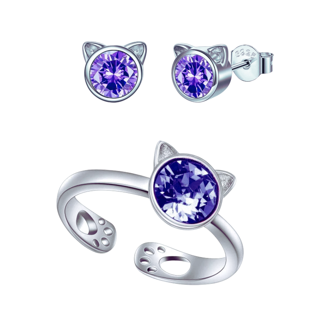 Silver cat-shaped earrings and ring with purple crystals on a white background