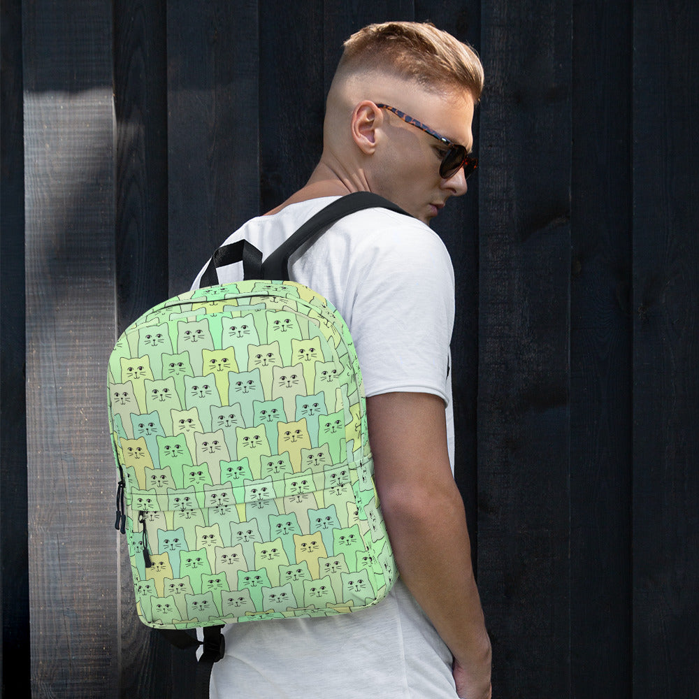 Man wearing green patterned cat backpack