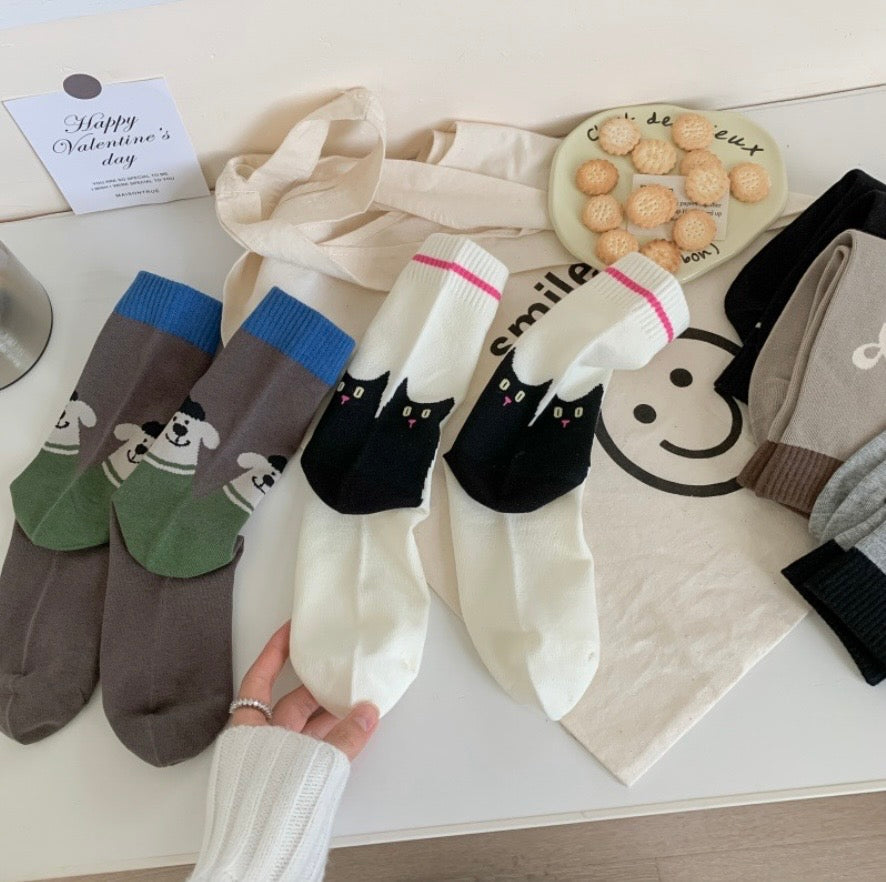 Set of colorful socks with animal designs on a white surface.
