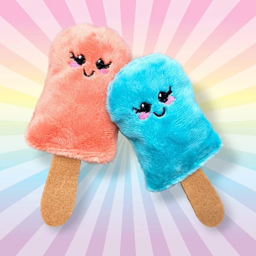 Two plush toys shaped like popsicles, one pink and one blue, on a colorful radial background.