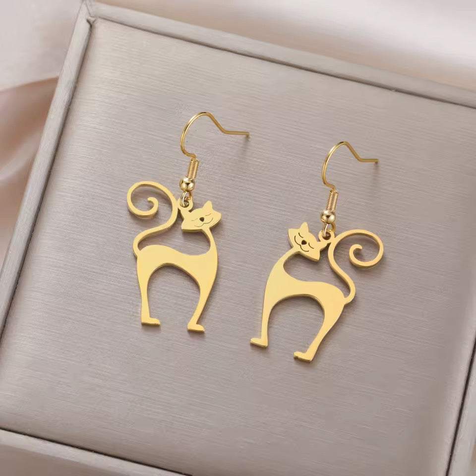 Groovy space race inspired Atomic Cat earrings in gold with french wires on a gift box