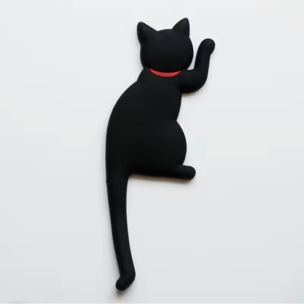 Black cat-shaped magnet with a bendy tail hook on a white background