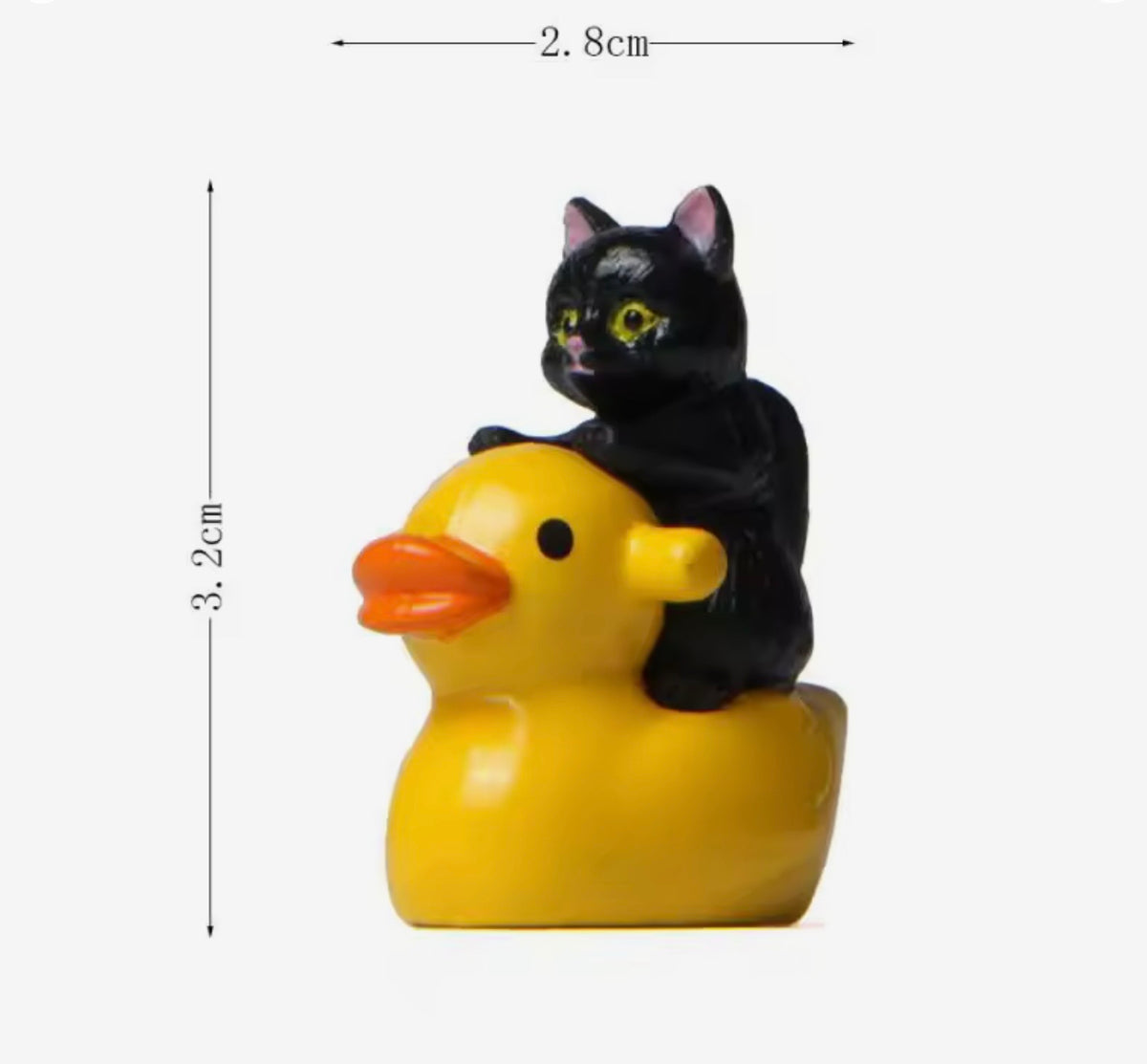 Black cat figurine on a yellow rubber duck with measurements indicated