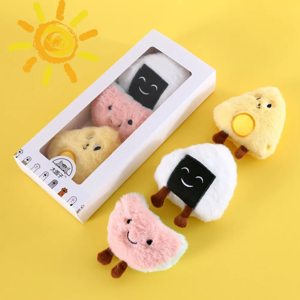 Plush catnip filled cat toys resembling food on a yellow background with a sun illustration.
