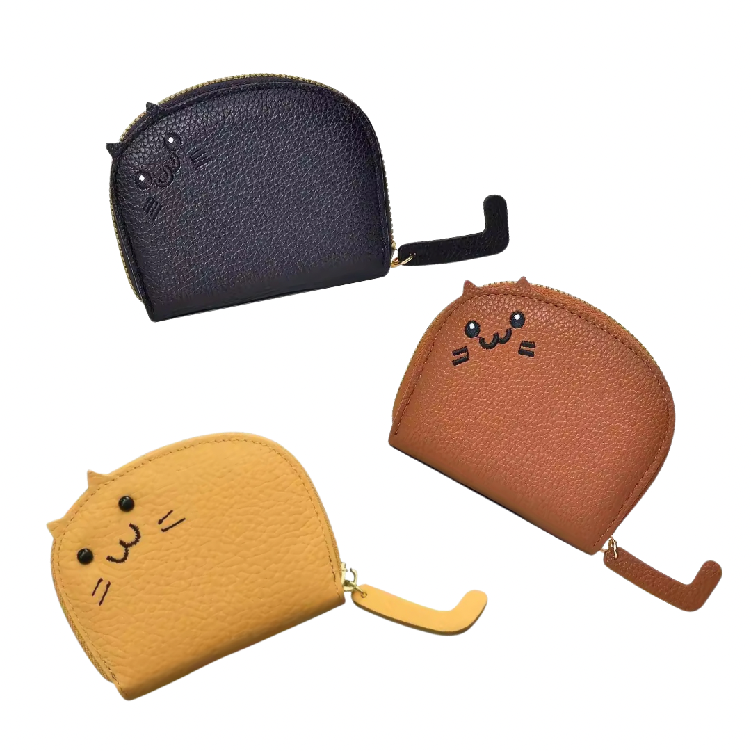Three cat-shaped coin purses in black, brown, and yellow on a white background