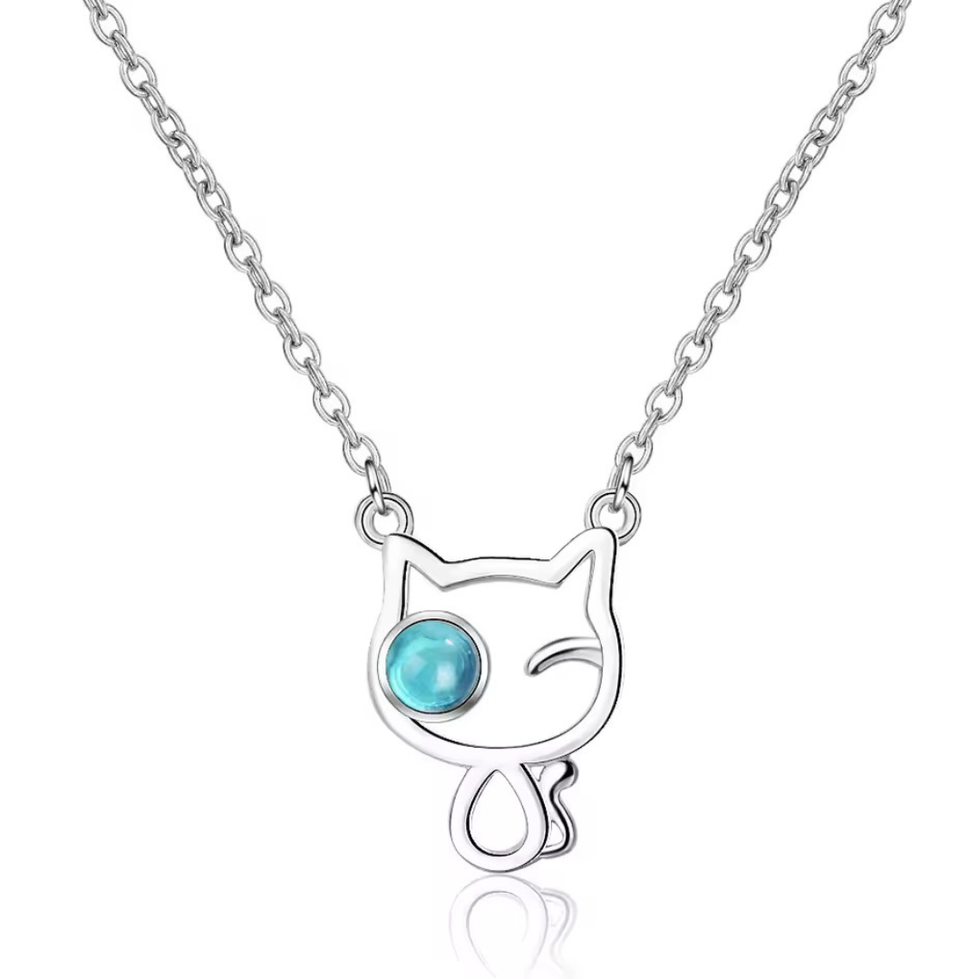 Cat-shaped necklace with a blue gem on a white background