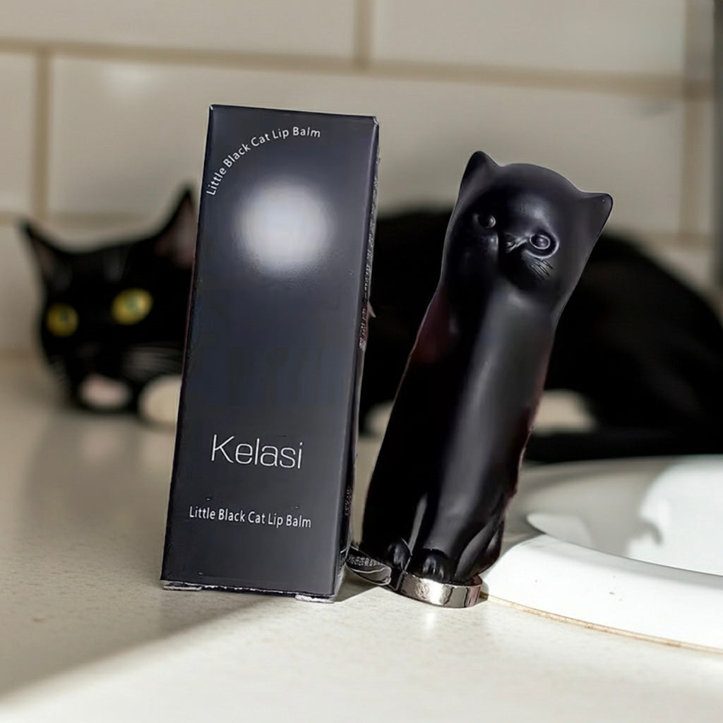 Black cat-shaped lip balm holder with 'Kelasi' branding on a bathroom counter.