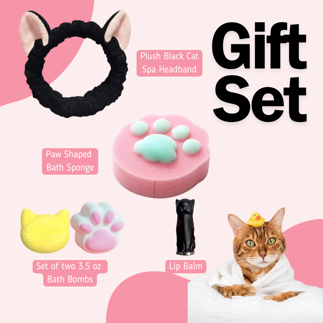 Cat-themed gift set with headband, Pink Paw print bath sponge, cat shaped bath bombs, black cat lip balm, and a cat in a robe on a pink background.