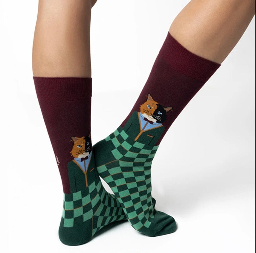 Pair of socks with gentlemen cats smoking jacket and bow tie on a white background