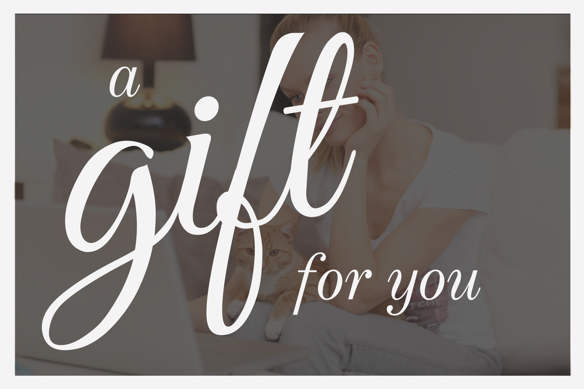 Text 'a gift for you' over a blurred background of a person with a cat.