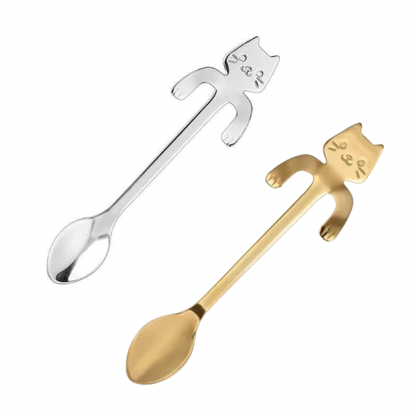 Gold and silver spoons with cat-shaped handles on a white background