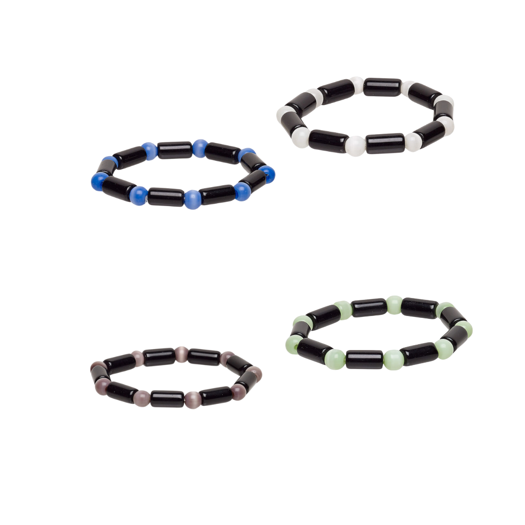 Set of four beaded bracelets with black, blue, white, purple and green beads on a white background