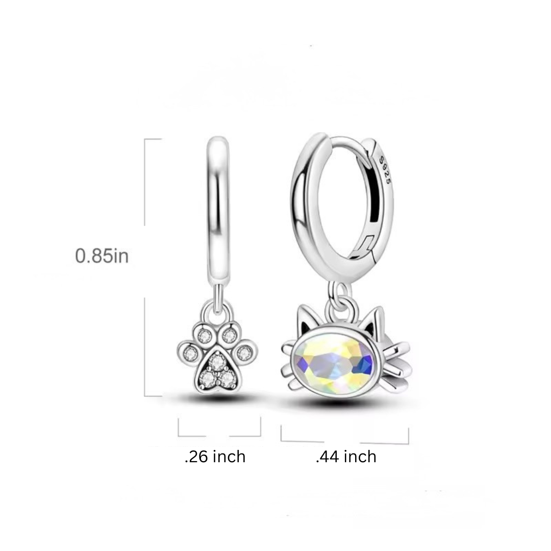 Two silver charm pendants with paw print and cat face design on a white background
