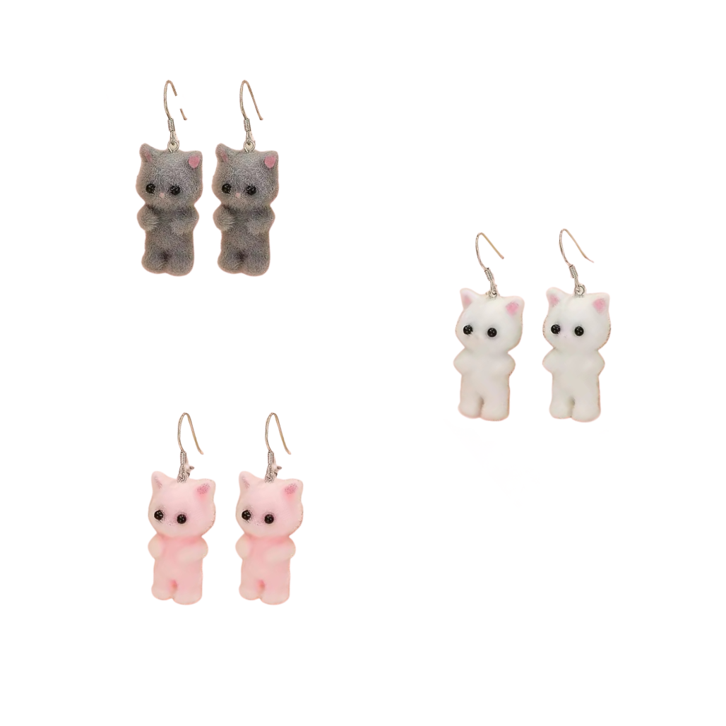 Set of three cat-shaped earrings in gray, white, and pink on a white background