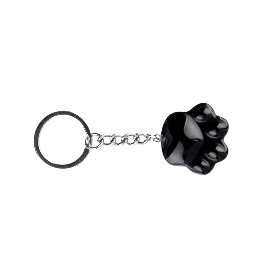 A glossy black paw print Onyx keychain with a silver metal chain and key ring, shown on a plain white background.