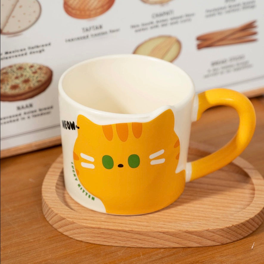 Orange striped cat mug with green eyes and whiskers with an orange handle on a wooden coaster in front of a menu.