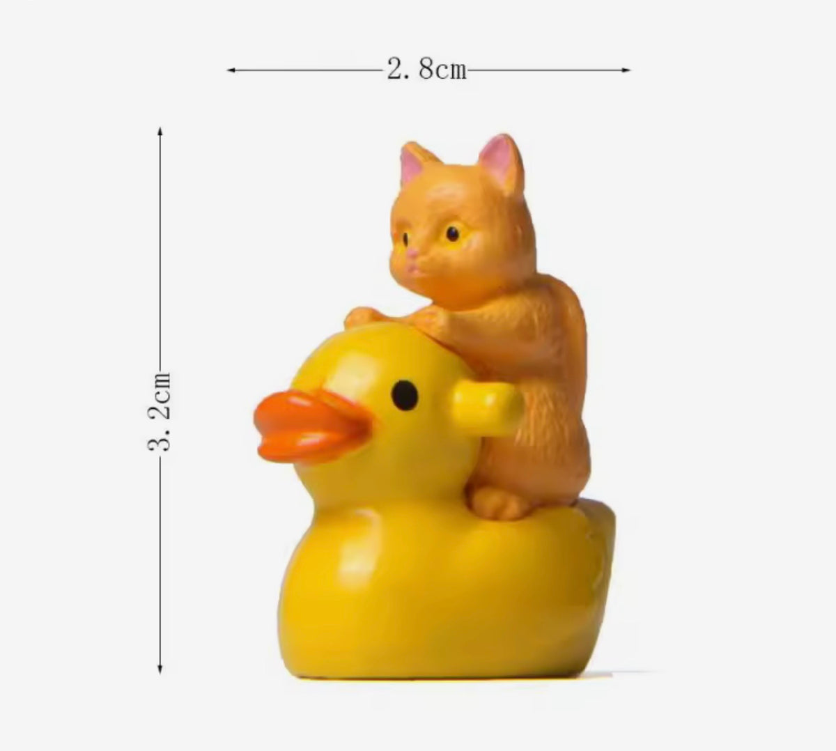 Small figurine of a cat riding a yellow rubber duck with dimensions indicated.