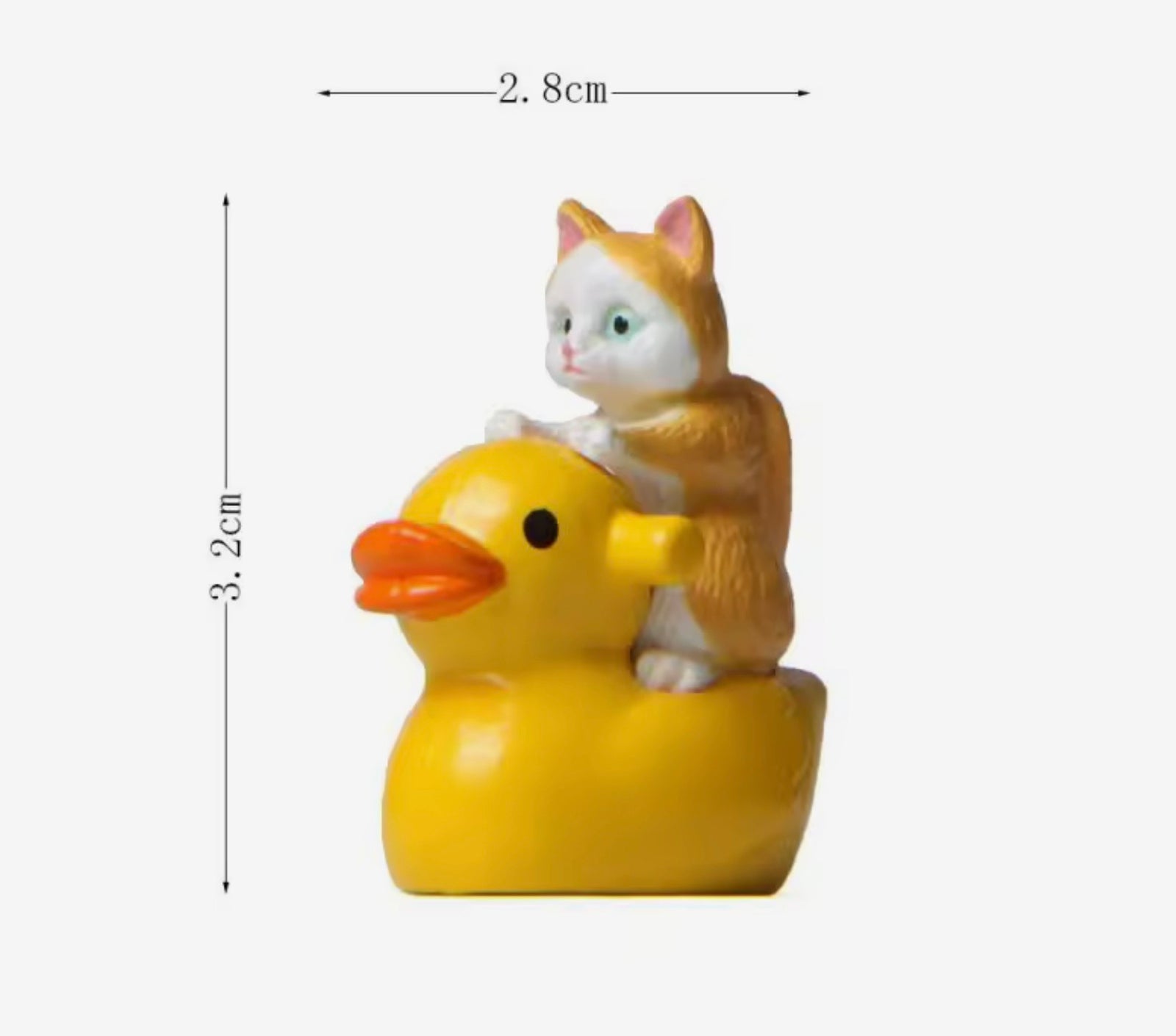 Small figurine of a cat riding a yellow duck with dimensions indicated.