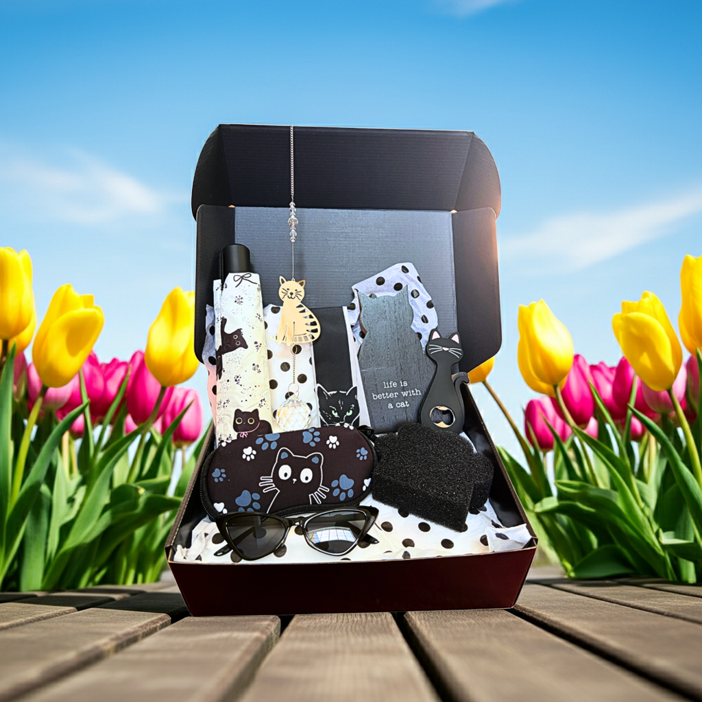 Set of cat-themed items in a box with tulips in the background
