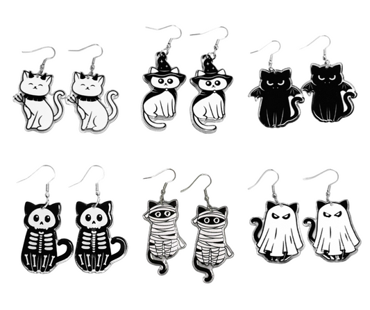 Set of black and white cat-themed earrings on a white background