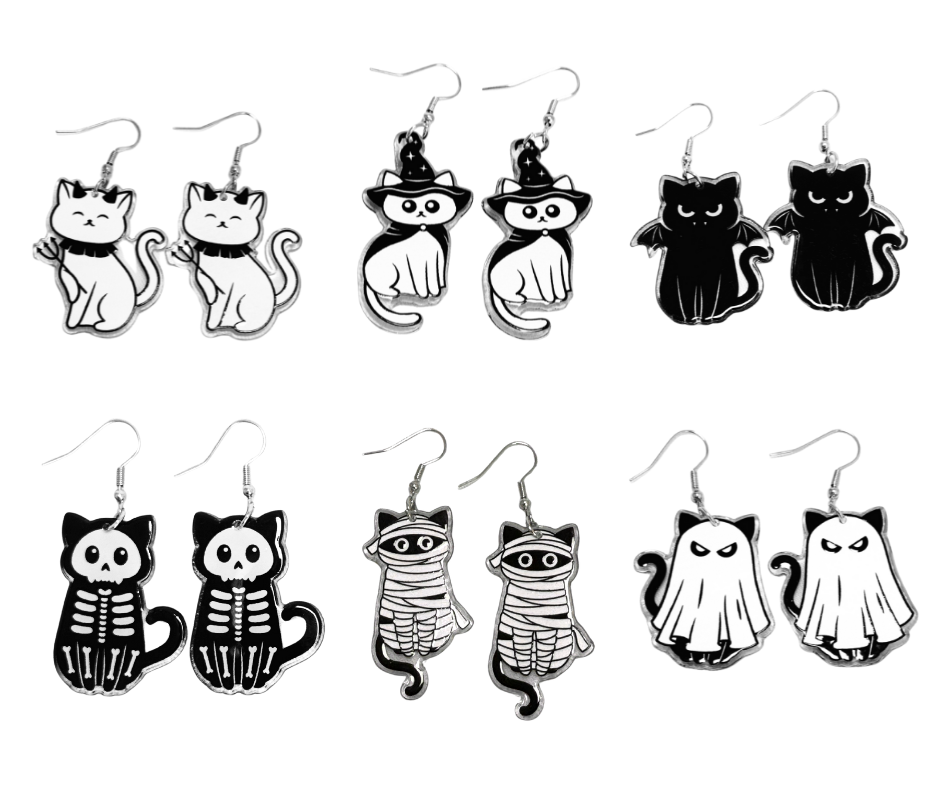 Set of black and white cat-themed earrings on a white background