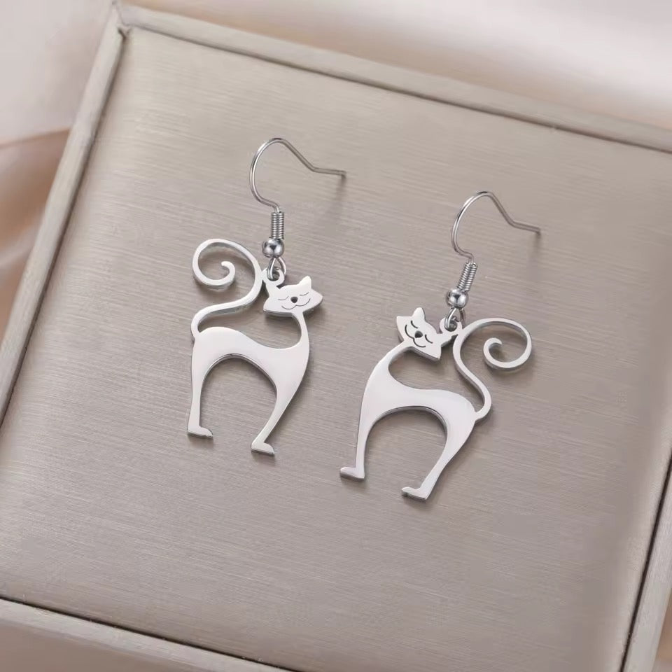 1960s style Atomic Cat earrings on a beige jewelry box