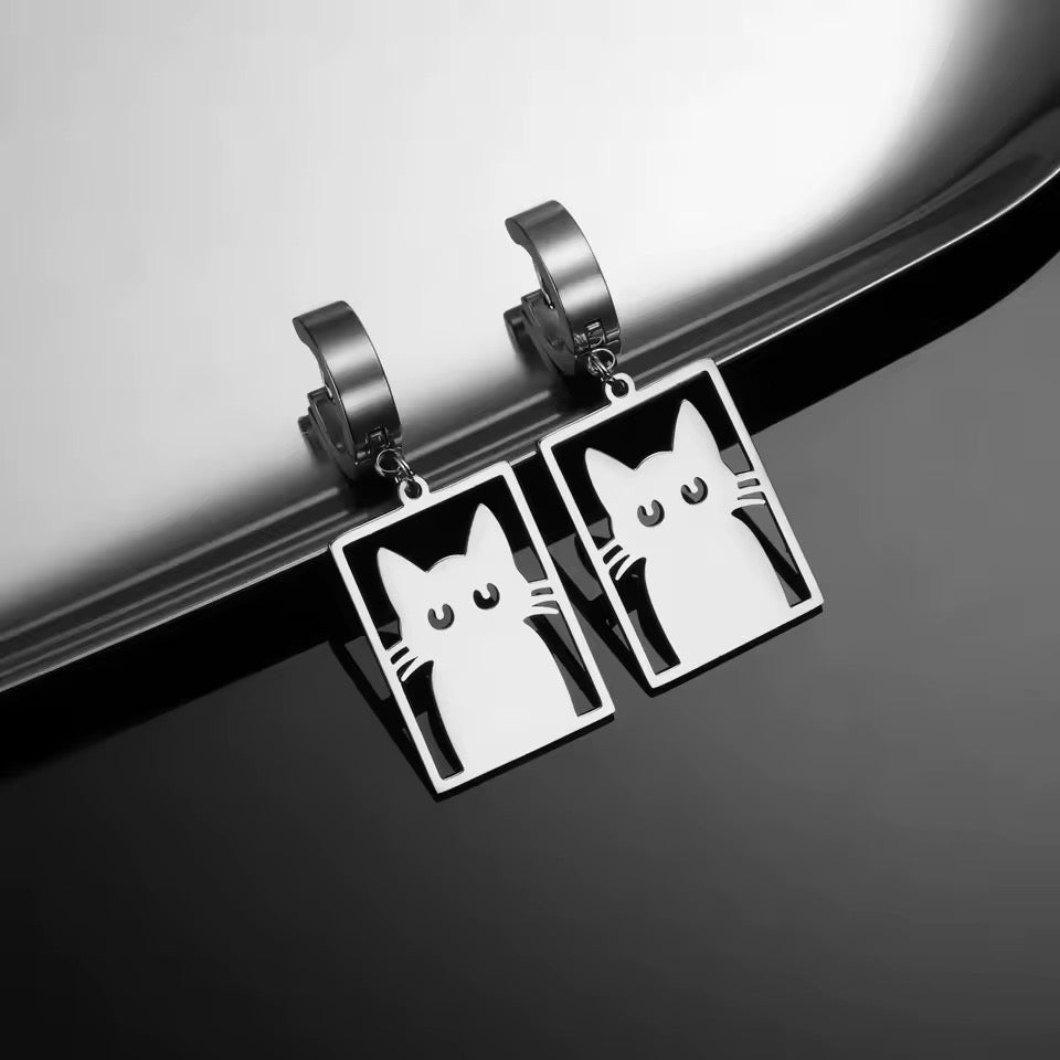 Silver hoop earrings feature a flat stainless cutout of a Cat in a Box on a silver reflective background.