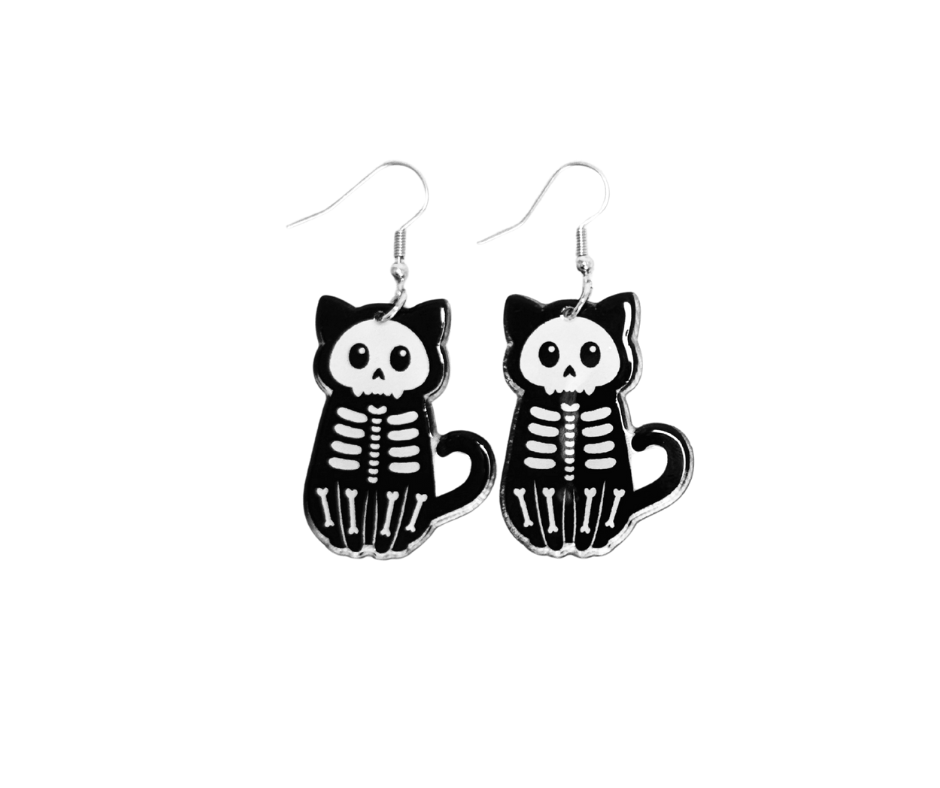 Cat skeleton earrings on a white background