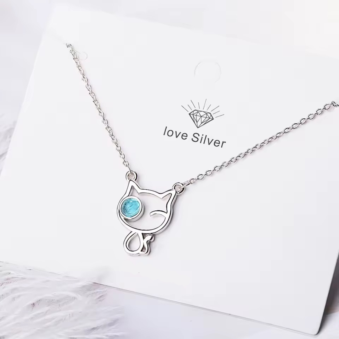 Silver cat-shaped necklace with a blue gemstone on a white card with 'love silver' branding.