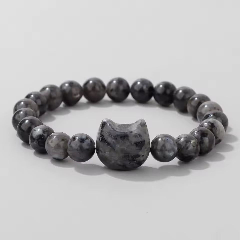 Labradorite natural stone beaded bracelet with a cat-shaped accent bead on a light gray background