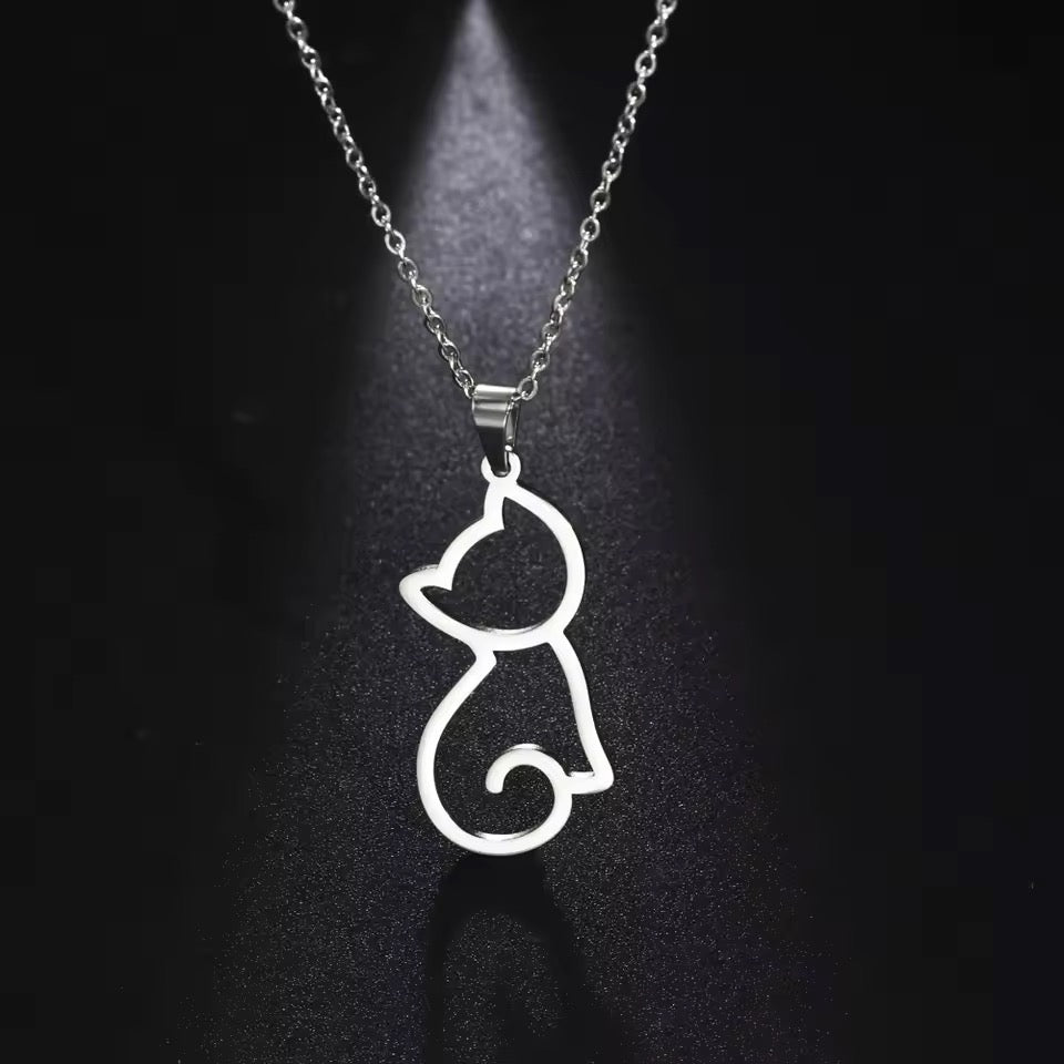 Silver cat-shaped pendant on a chain against a dark background