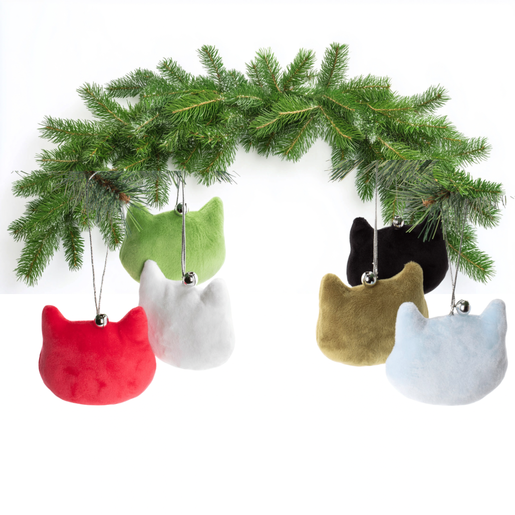 Colorful cat-shaped Christmas ornaments hanging from a branch on a white background