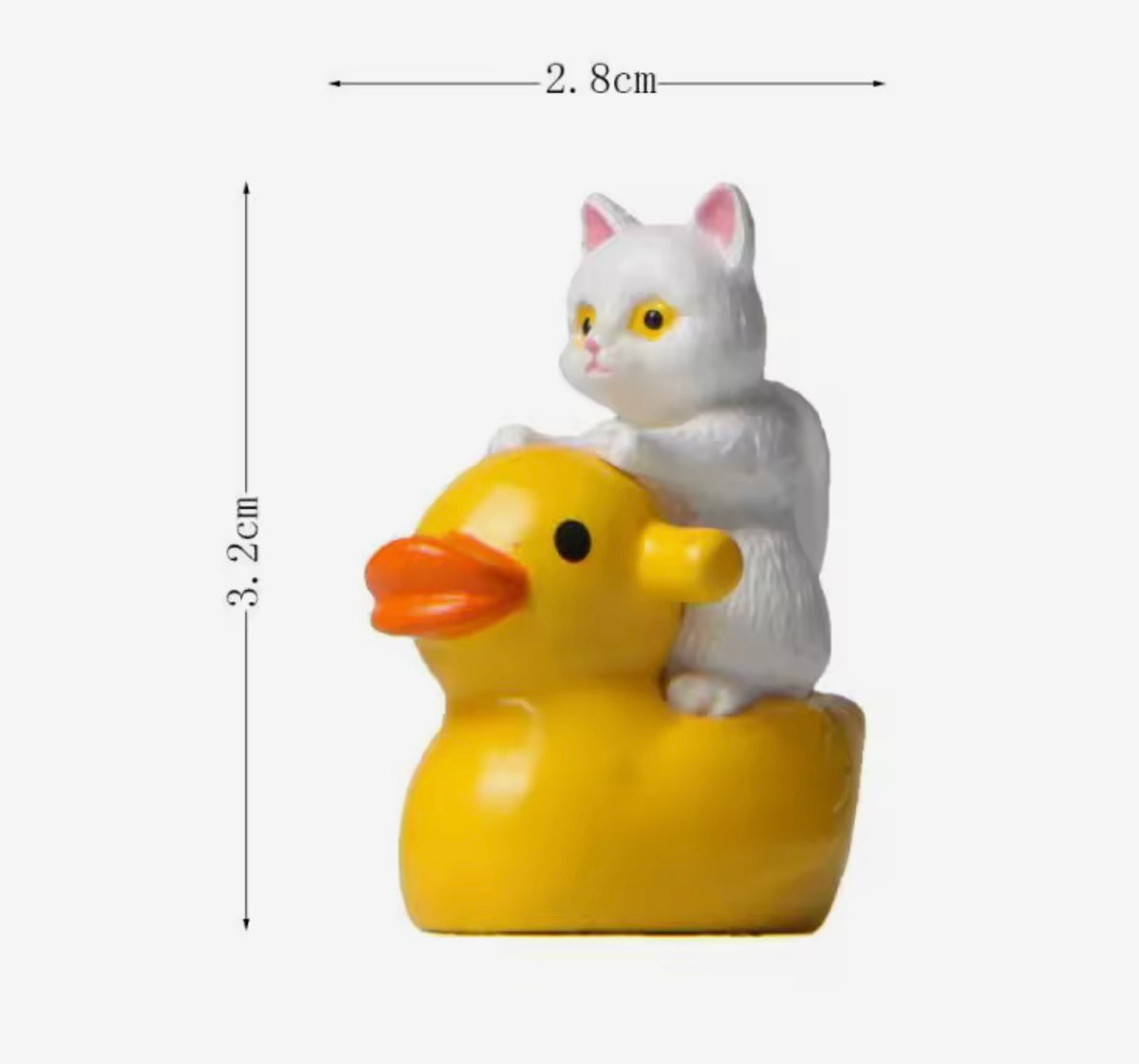 White cat figurine on a yellow rubber duck with dimensions indicated