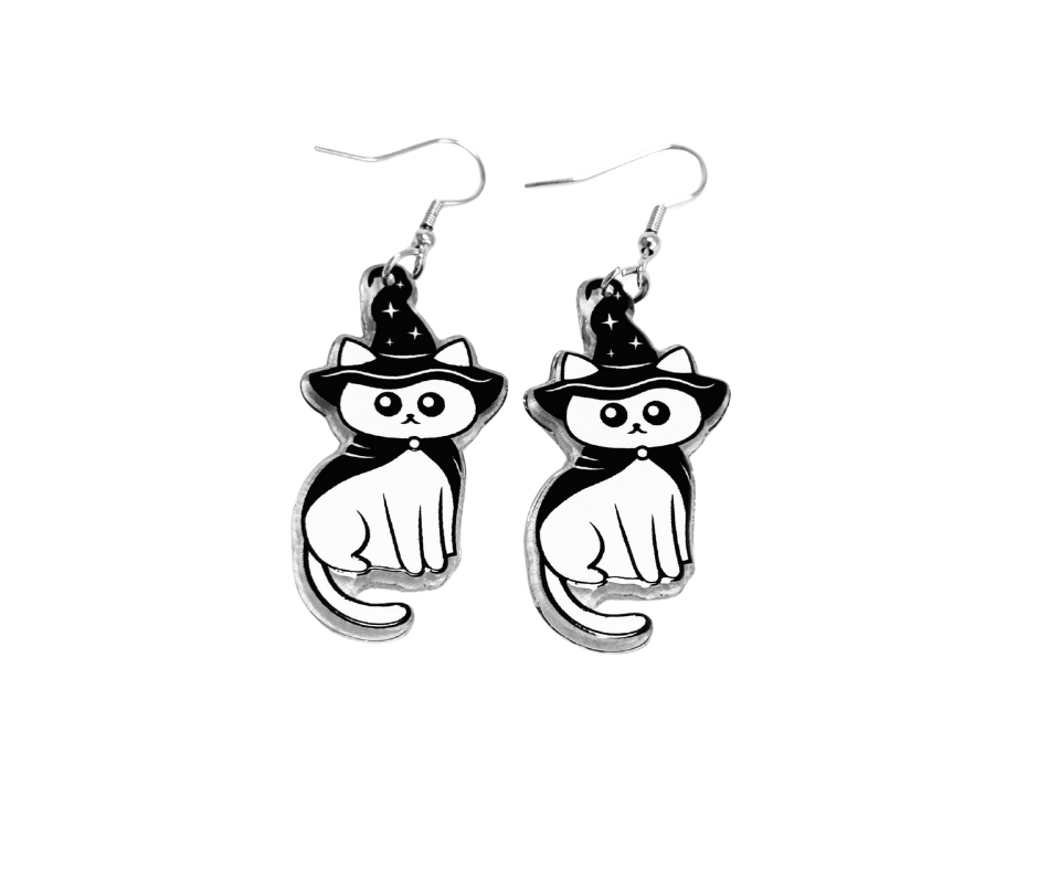 Black and white cat earrings with witch hats on a white background