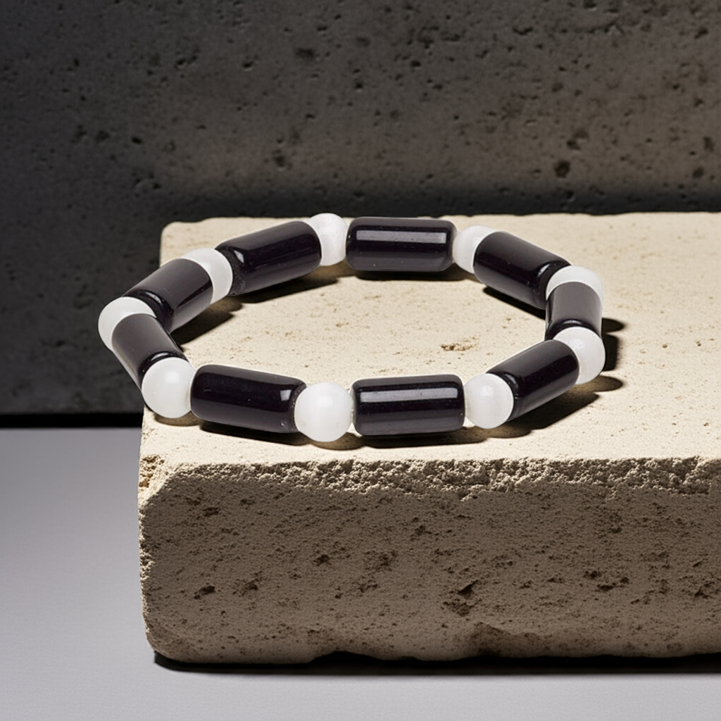 black and white beaded bracelet sitting on concrete block