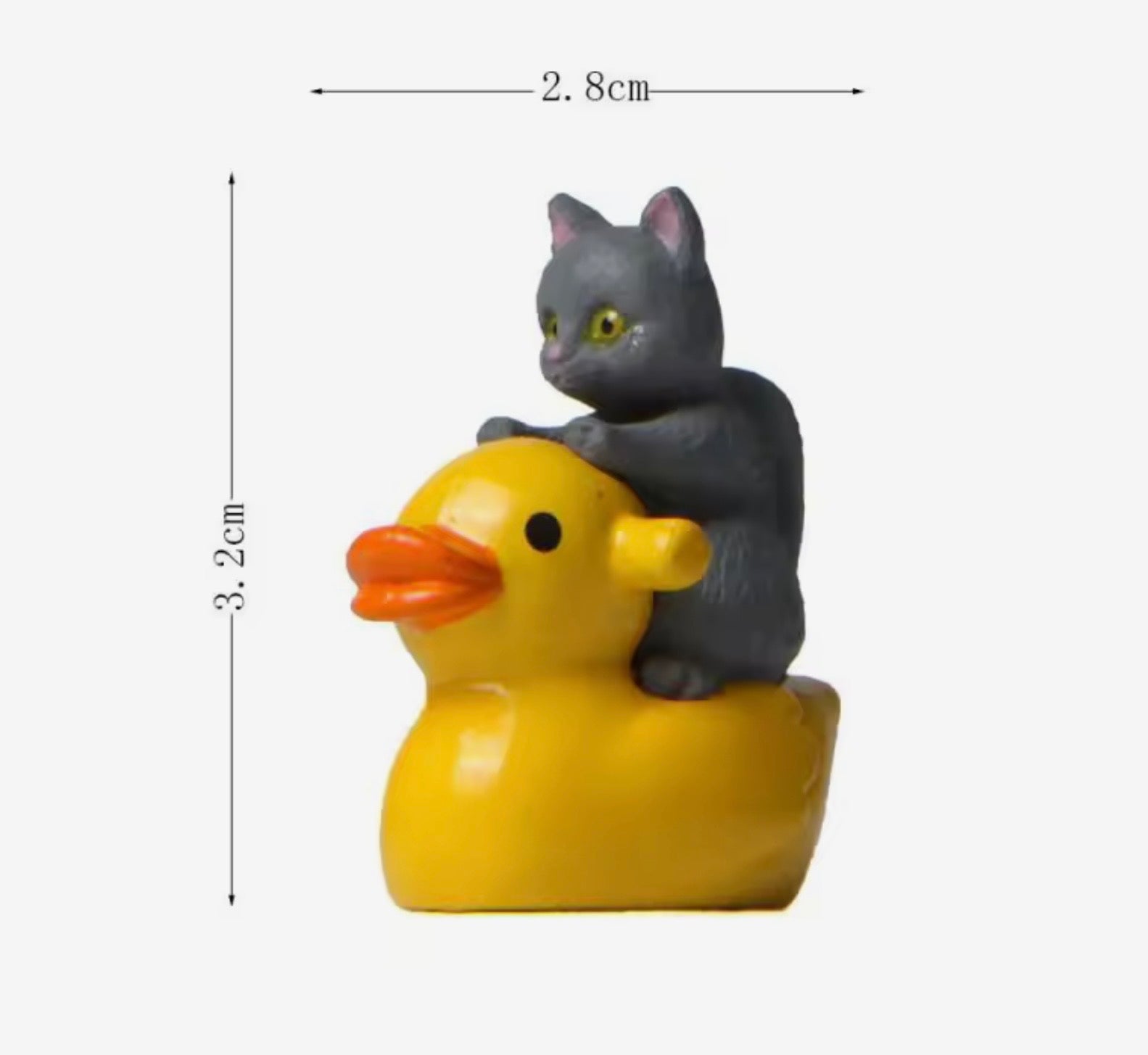 Small figurine of a gray cat riding a yellow rubber duck with dimensions indicated.