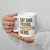 person holding white mug that says cat dad, friend, protector, hero