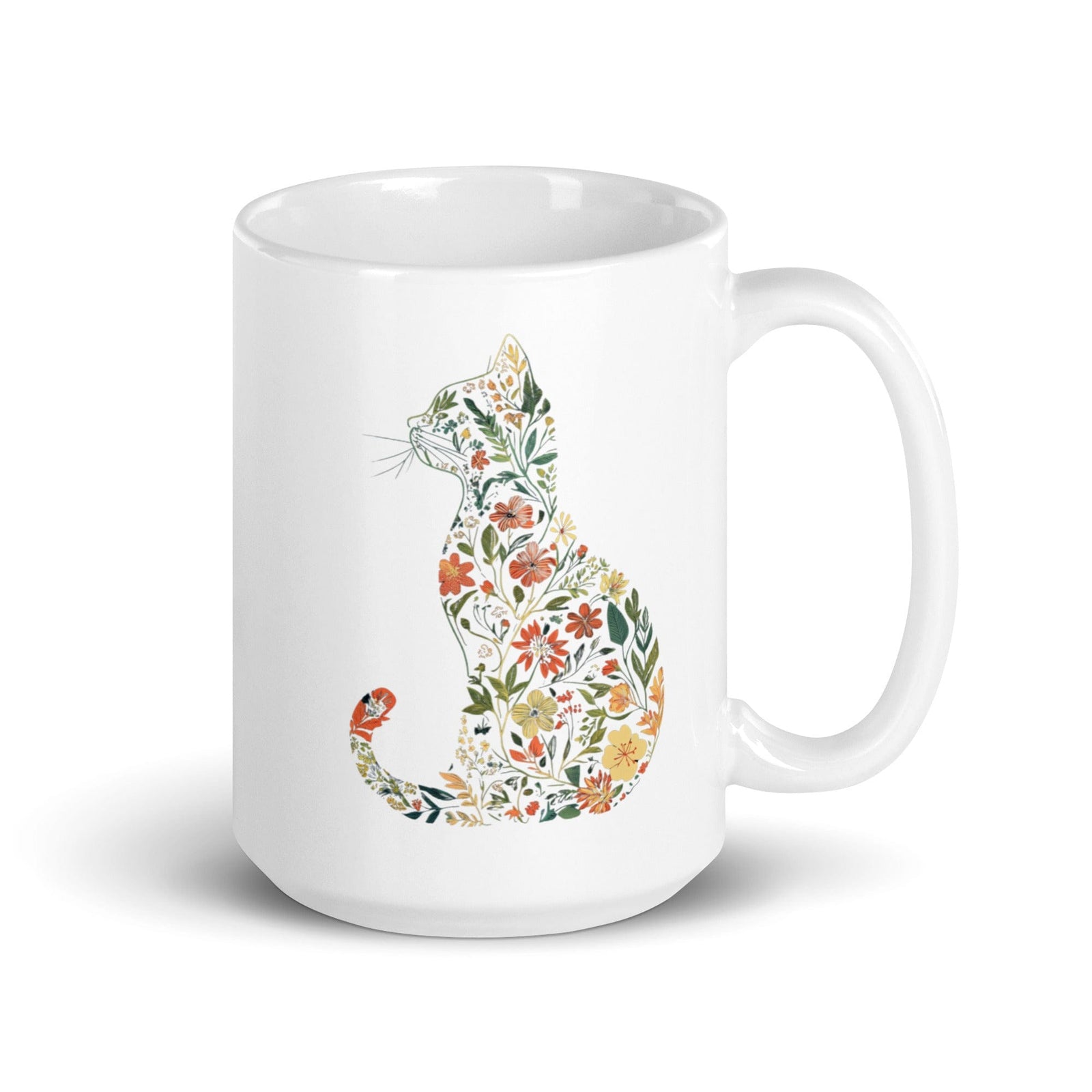 A white ceramic mug with a colorful floral silhouette of a cat on the side.