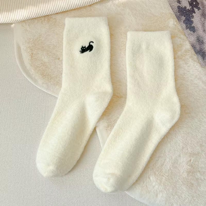 White fuzzy socks with embroidered black cat featured on white background
